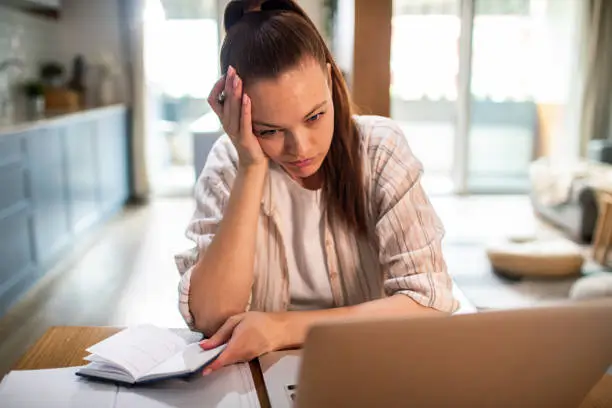 a woman looking tired and stressed of her debt